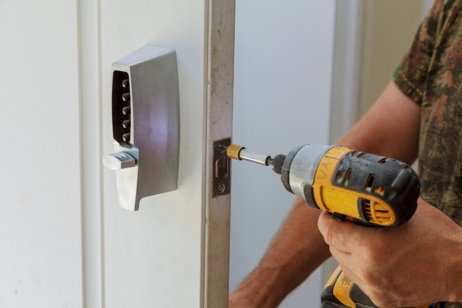 Man installing of the door with lock key security