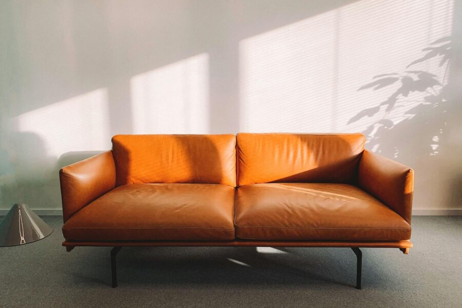 2-seat Orange Leather Sofa Beside Wall