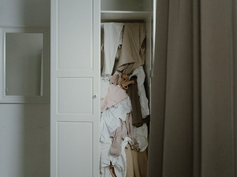 Photo of an Untidy and Messy White Wooden Closet