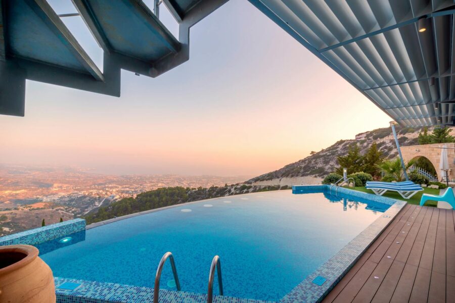 Infinity pool with breathtaking mountain and city views, perfect for a luxury tropical getaway.