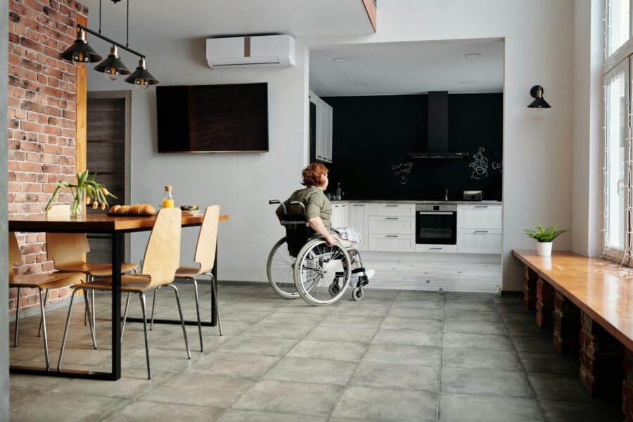 photo of woman on wheelchair going to the kitchen