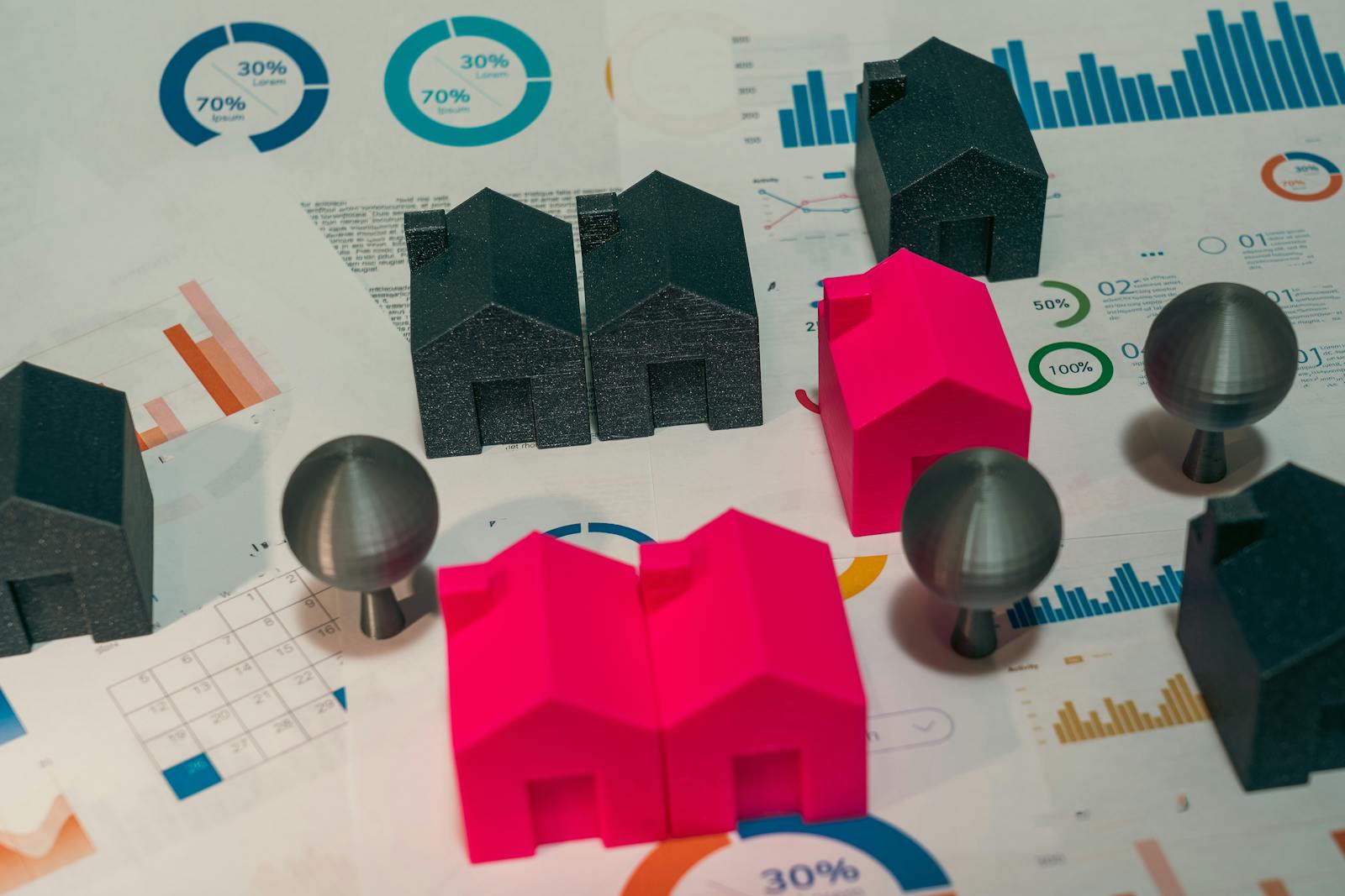 Abstract representation of real estate market analysis with model houses and charts.