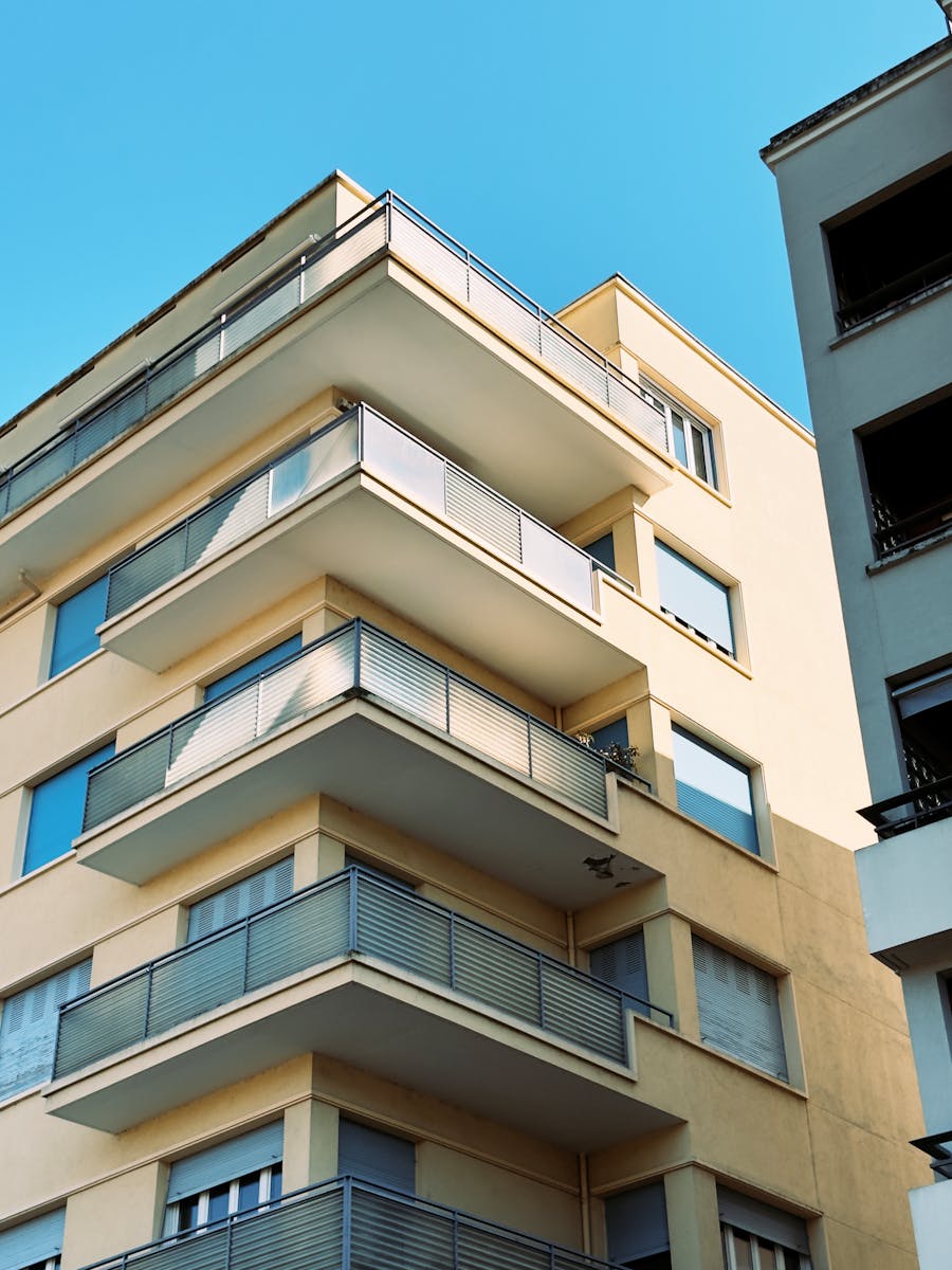 Explore the contemporary architecture of a Villefranche-sur-Saône apartment building with sleek balconies.