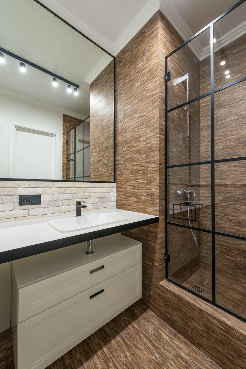 A clean and contemporary bathroom featuring a stylish shower and sleek fixtures.